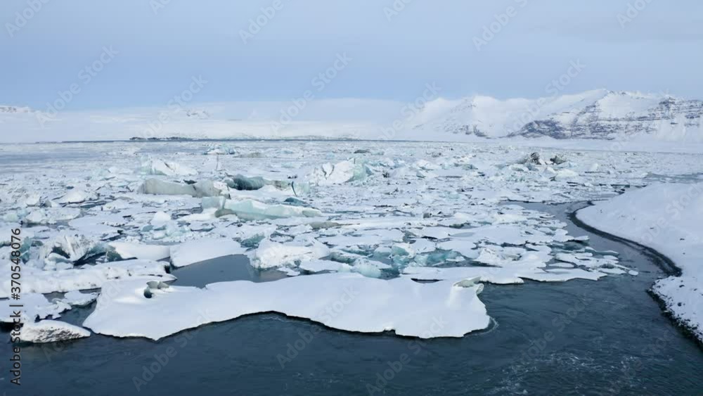 AERIAL: Flying towards Snowy Ice Floes on Iceland Lake Winter, Snow AERIAL: Flying towards Snowy Ice Floes on Iceland Lake Winter, Snow