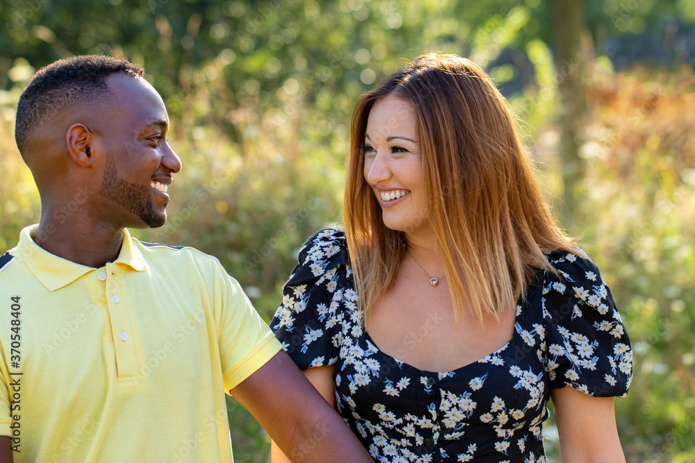 Outdoor portrait of diverse young couple in park Outdoor portrait of diverse young couple in park