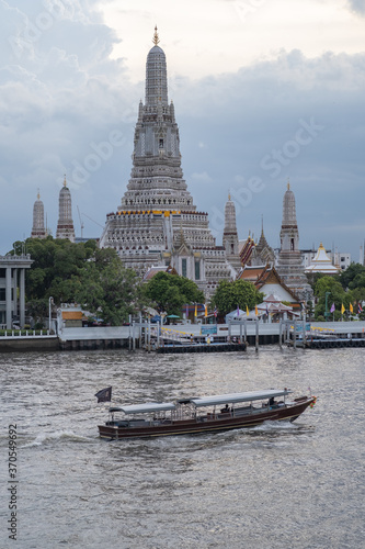 BANGKOK - AUG 6, 2020 : Wat Arun Ratchawararam Ratchawaramahawihan or Wat Arun is a Buddhist temple in Bangkok Yai district of Bangkok, Thailand, on the Thonburi west bank of the Chao Phraya River. © Arucha