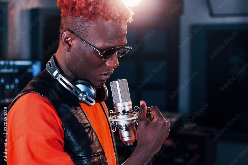 Young african american performer rehearsing in a recording studio