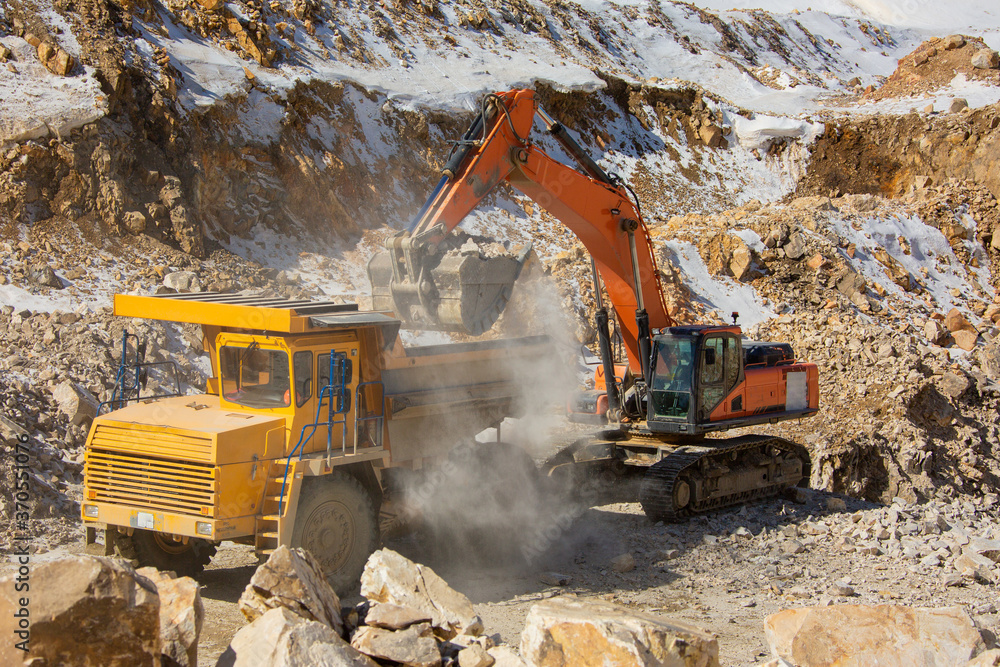 Quarry extraction of silicon. Minerals. Loading and transportation of minerals. Truck and excavator Quarry extraction of silicon. Minerals. Loading and transportation of minerals. Truck and excavator