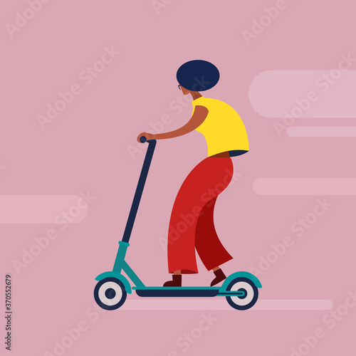 A dark skinned girl rides an eco friendly non polluting electric scooter 