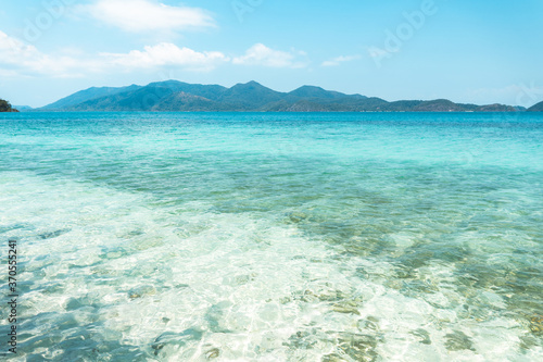 Clear water on the island,Bright blue sea and wooden boat The tourism