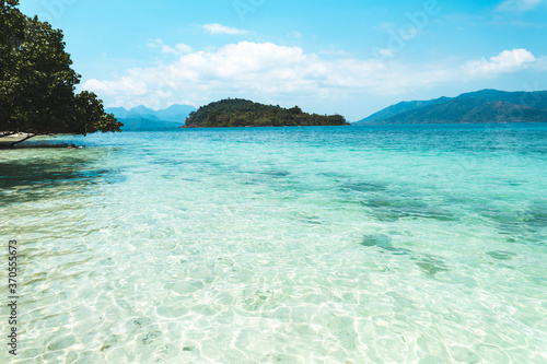 Clear water on the island,Bright blue sea and wooden boat The tourism