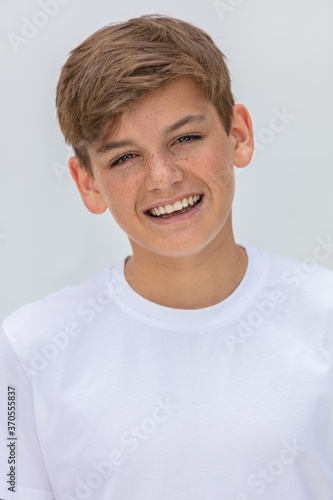 Boy teenager teen male child smiling happy and wearing a white t-shirt