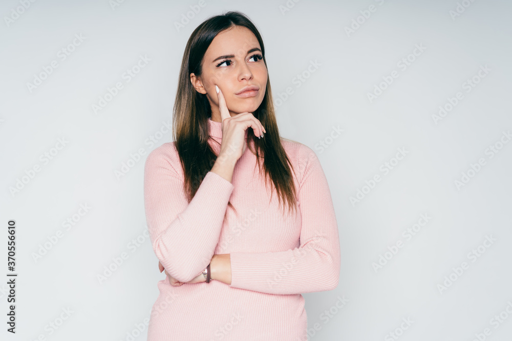 Thoughtful woman with hand on chin Thoughtful woman with hand on chin