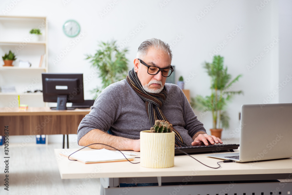 Old male employee working from house during pandemic Old male employee working from house during pandemic