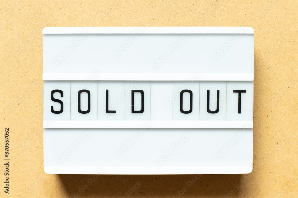 Lightbox with word sold out on wood background Lightbox with word sold out on wood background