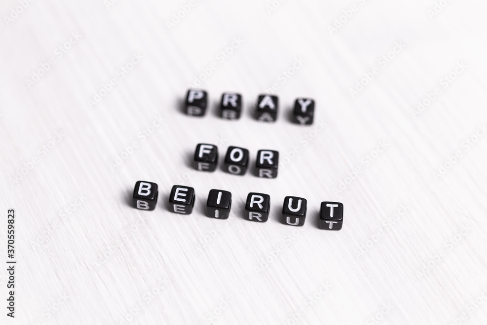 Fototapeta premium Pray for Beirut sign. Show of support in response to 2020 Lebanon Explosion. Message of solidarity and support. Words pray for Beirut on white background.