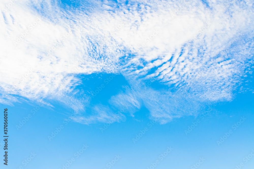 Blurred background. Blue sky and white fluffy clouds. Blurred background. Blue sky and white fluffy clouds.