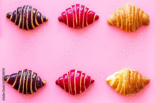 Set of croissants - chocolate, berry, classic - on pink desk top view © 279photo