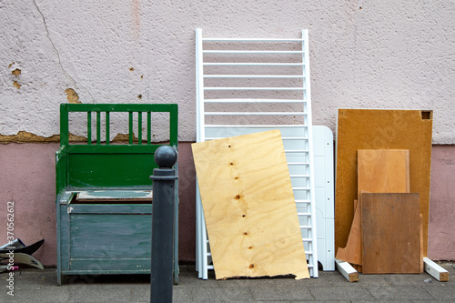 Bilde på lerret Bulky waste with an old wooden bench, boards and a cot