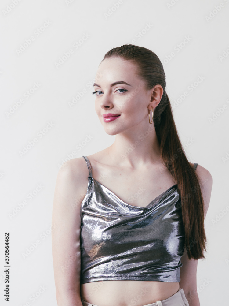 Beautiful brunette woman girl with long hair smooth and beauty in silver wear Beautiful brunette woman girl with long hair smooth and beauty in silver wear