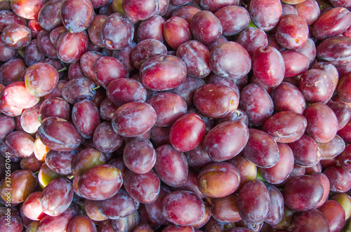 Fresh ripe red plums as a background