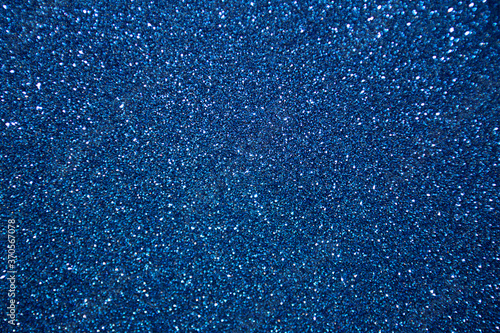 Abstract glitter christmas blue background. Shimmer bright background with bokeh blue lights. Shiny gradient with copy space