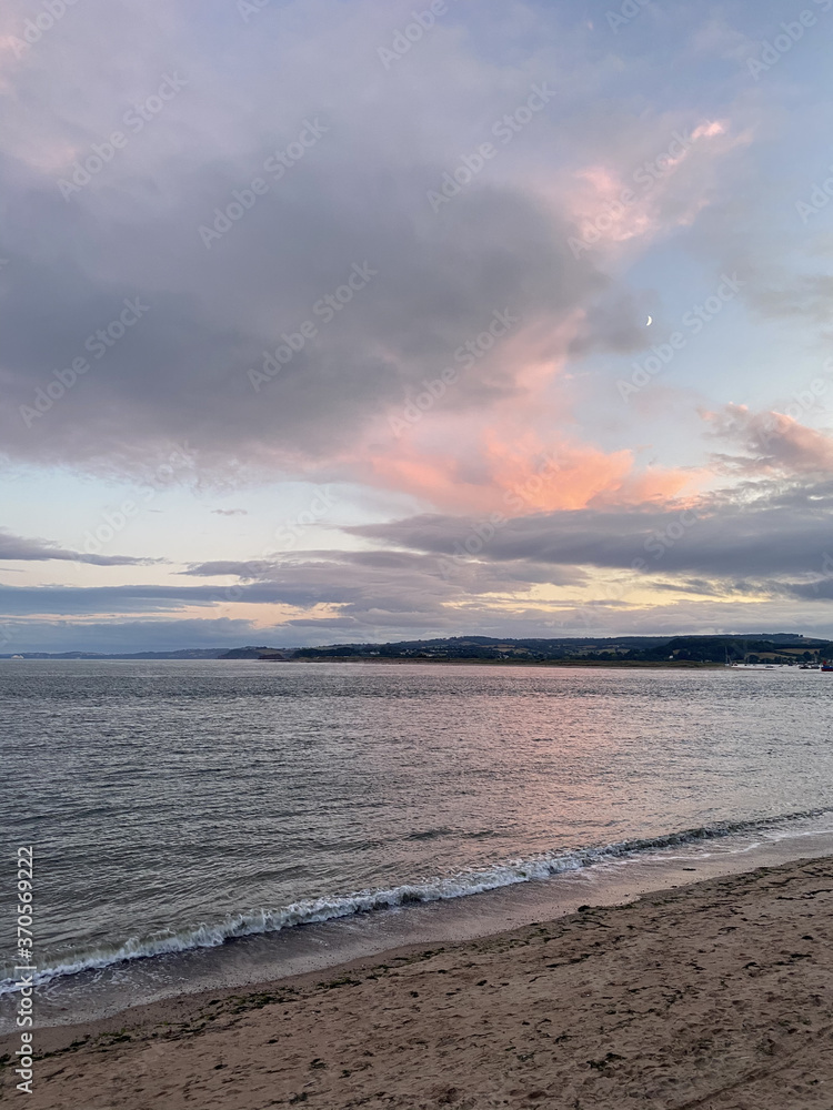 Pink sky sunset moon over beach Pink sky sunset moon over beach