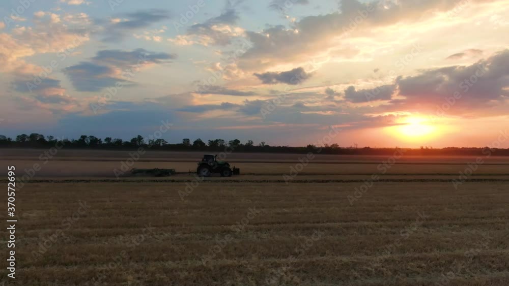 field work at sunset,
tractor works the land,
the tractor is driving across the field,
the drone flies behind the tractor over the field field work at sunset,
tractor works the land,
the tractor is driving across the field,
the drone flies behind the tractor over the field