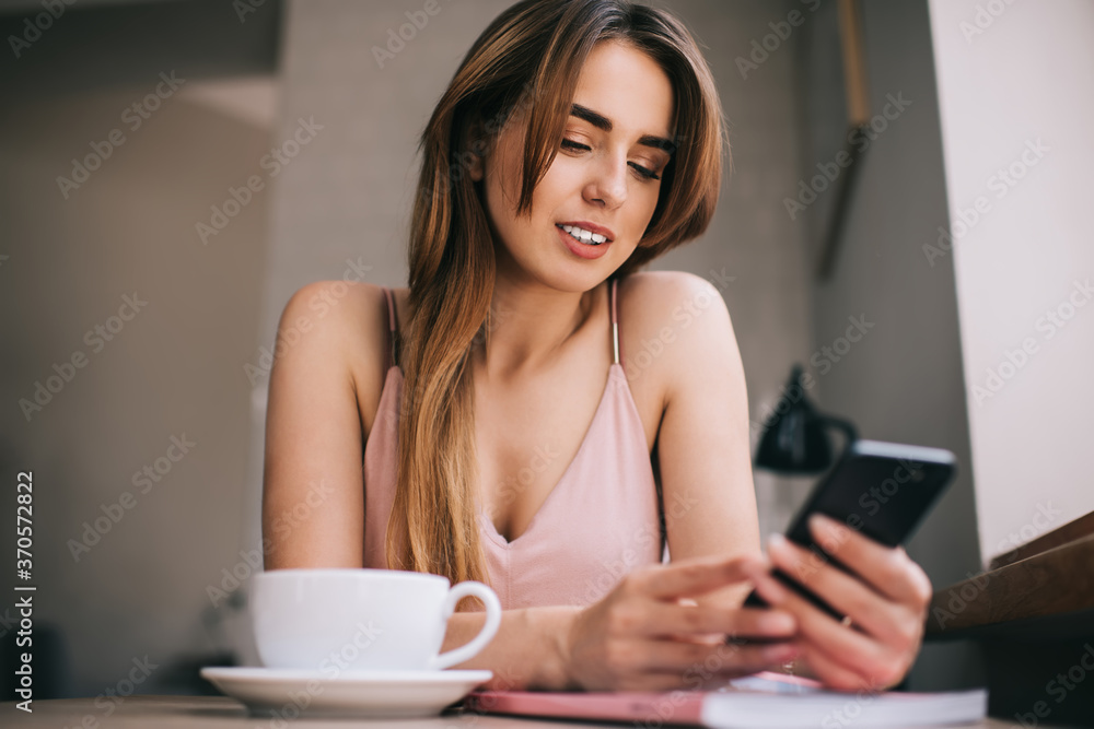 Concentrated woman browsing smartphone while sitting at home Concentrated woman browsing smartphone while sitting at home