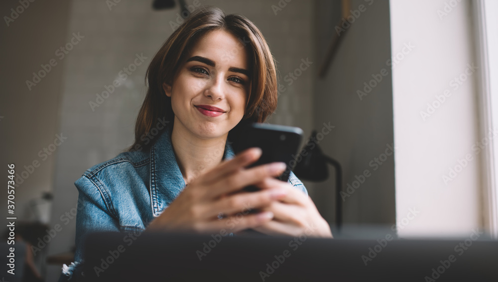 Satisfied woman using smartphone in cafe Satisfied woman using smartphone in cafe