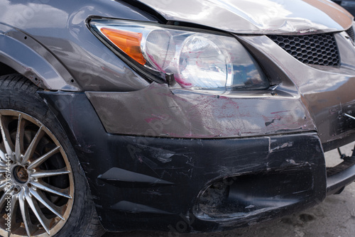 car with a broken bumper and badly scratched after an accident top view