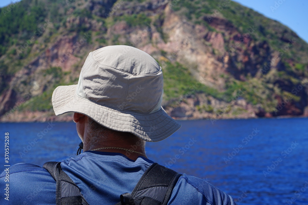 Tourist in front the sea - Lipari island in Italy