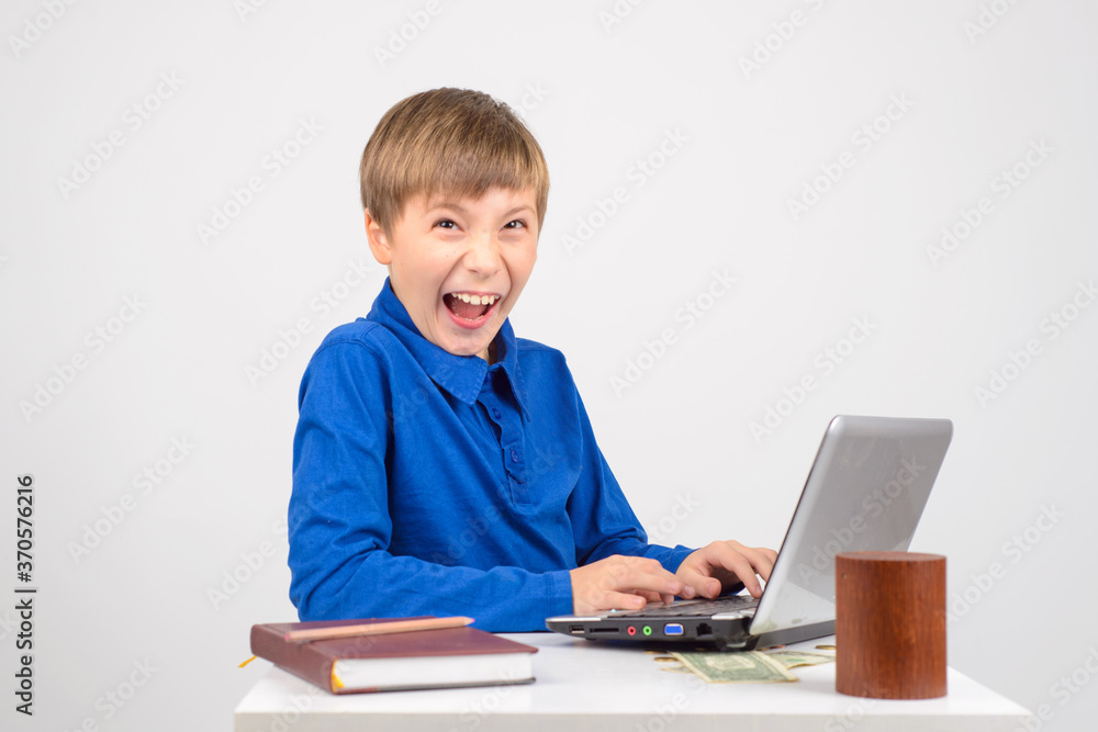 the young hacker: a Young smart boy with a netbook recklessly ha the young hacker: a Young smart boy with a netbook recklessly ha