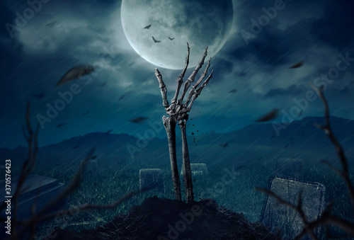 Billede på lærred Zombie skeleton hand rising in dark Halloween night.