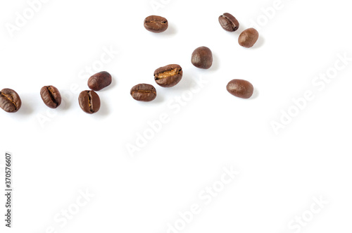Roasted coffee beans on wooden texture background.