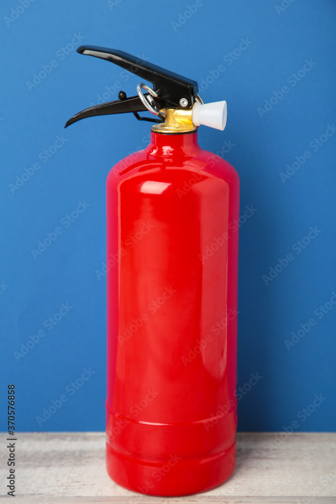 Fire extinguisher on the blue background. Top view. Fire extinguisher on the blue background. Top view.