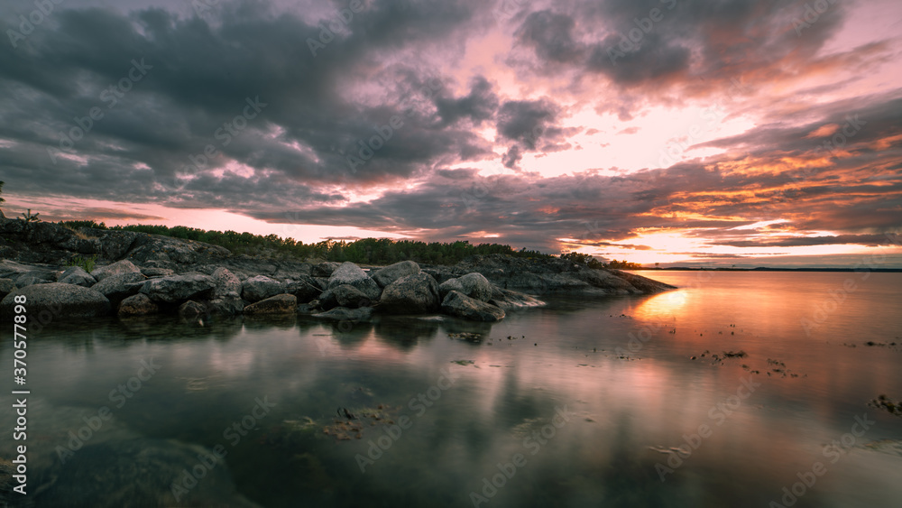 Abstract beach scape at sunset with clouds