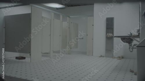 Stall door mysteriously opening in public restroom interior