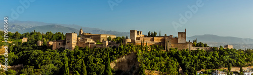 A panorama view from Saint Nicholas Square, Granada, Spain towards the Alhambra Palace and the Sierra Nevada mountains in the distance in the summertime