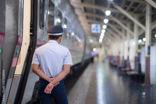 A security guard stands guard at a train station