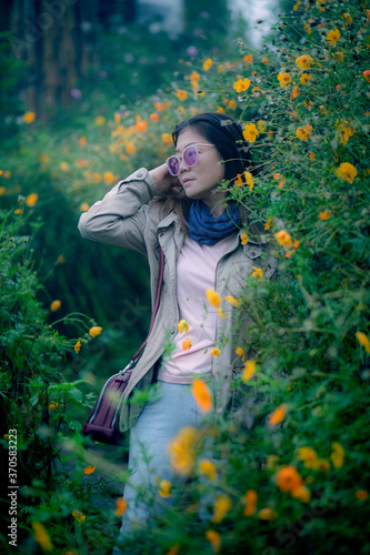woman in yellow flower blooming field