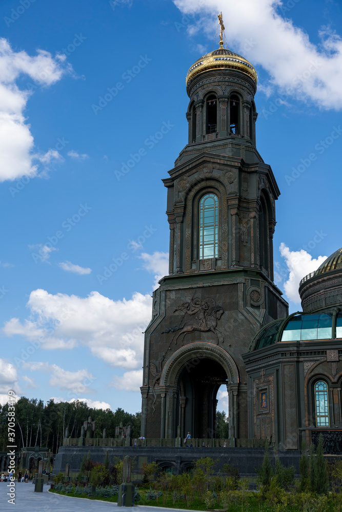 panoramic view of a dark temple with golden domes against a background of gray clouds panoramic view of a dark temple with golden domes against a background of gray clouds