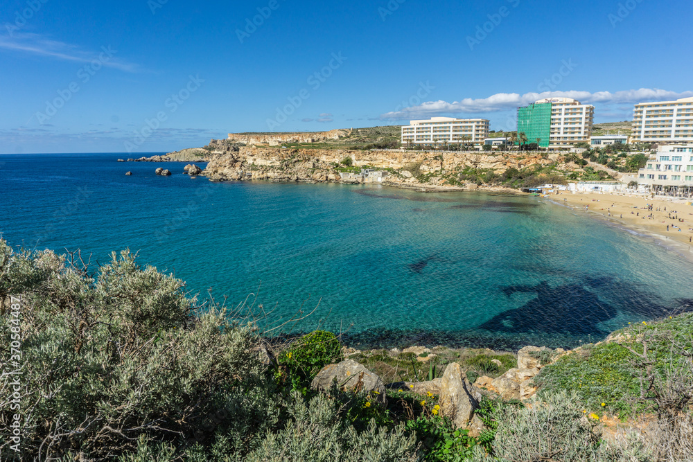 Coastal hike by Golden Bay beach in Malta with beautiful blue ocean