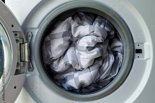 Fényképezés Duvet inside washing machine, Cleaning blanket.