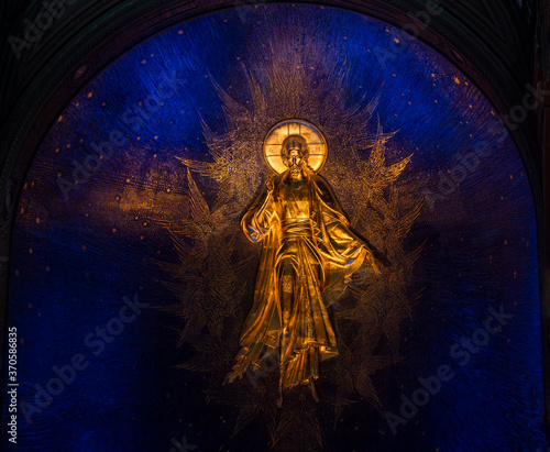 bright frescoes and symbolic objects of a religious nature on the wall in the temple