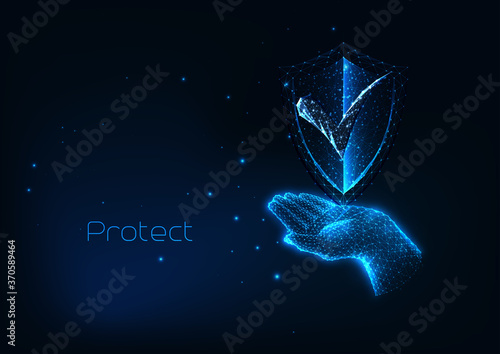 Futuristic protection cyber security concept with glow low polygonal hand holding protective shield