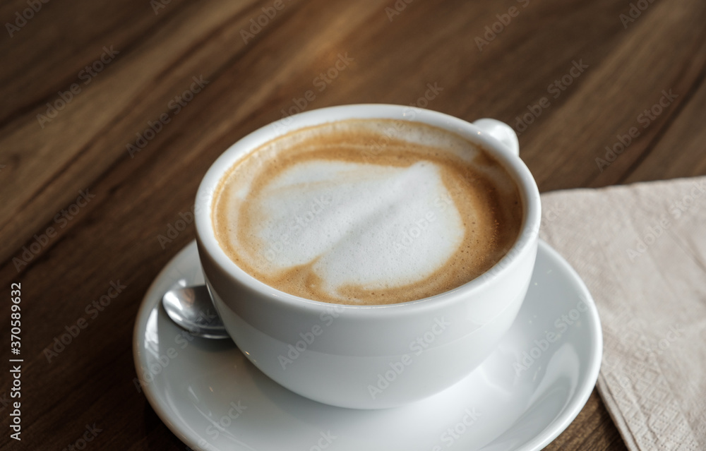 closed-up of hot drink coffee in white mug on brown wood table closed-up of hot drink coffee in white mug on brown wood table