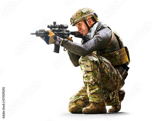Army soldier in Protective Combat Uniform holding Special Operations Forces Combat Assault Rifle isolated on white background