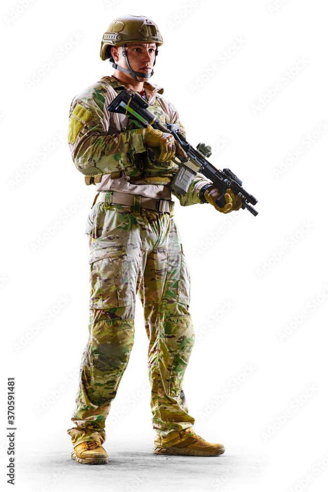 Army soldier in Protective Combat Uniform holding Special Operations Forces Combat Assault Rifle isolated on white background Army soldier in Protective Combat Uniform holding Special Operations Forces Combat Assault Rifle isolated on white background