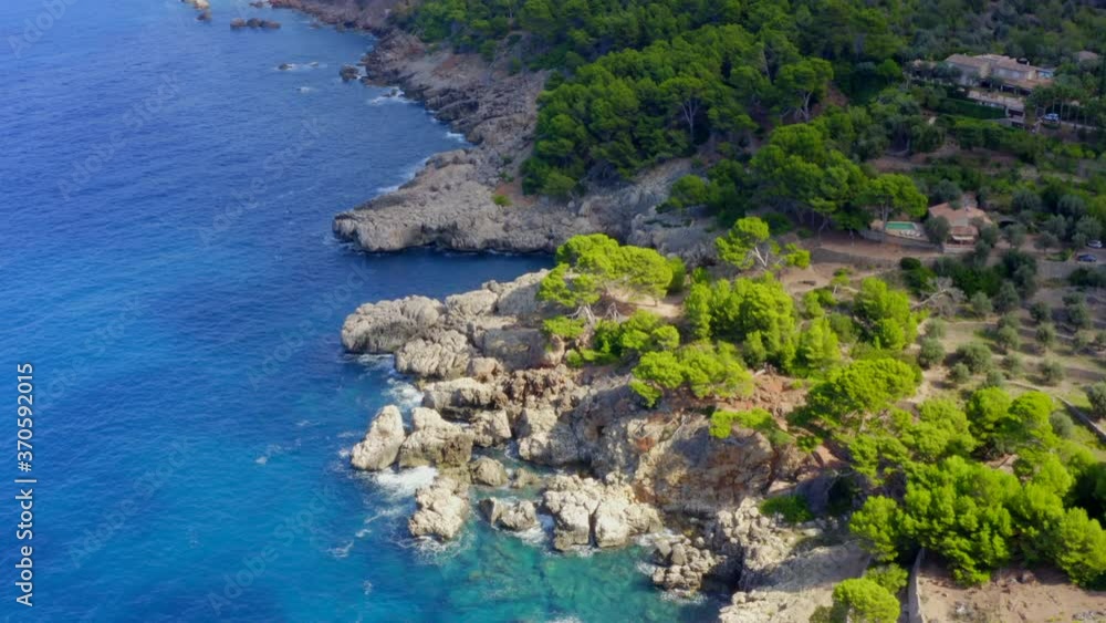 AERIAL: Over Beautiful Coast Line of Tropical Island Mallorca, Spain with ocean and Blue water in Summer,Daylight Vacation, Travel, Sunny, Waves AERIAL: Over Beautiful Coast Line of Tropical Island Mallorca, Spain with ocean and Blue water in Summer,Daylight Vacation, Travel, Sunny, Waves