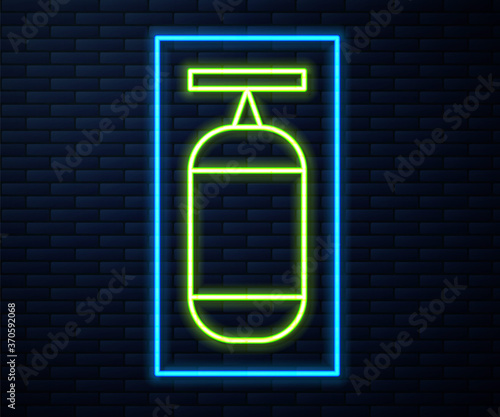 Glowing neon line Punching bag icon isolated on brick wall background. Vector Illustration.