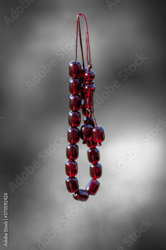 Amber greek traditional rosary on blurry background. Greek worry beads. Komboloi, orthodox rosary used frequently by men.