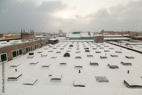 Roof of industrial factory covered with snow