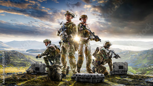 Army soldiers in Protective Combat Uniform holding Special Operations Forces Combat Assault Rifle on dark background photo