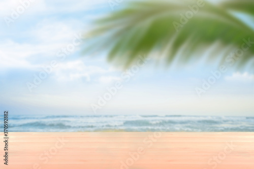 blank wood table countertop with softfocus palm and summer beach background