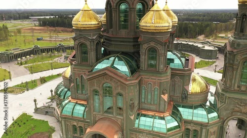 dark color temple with golden domes with geometric park from drone height