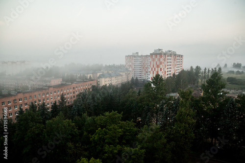 Foggy morning landscape in a residential area with apartment buildings